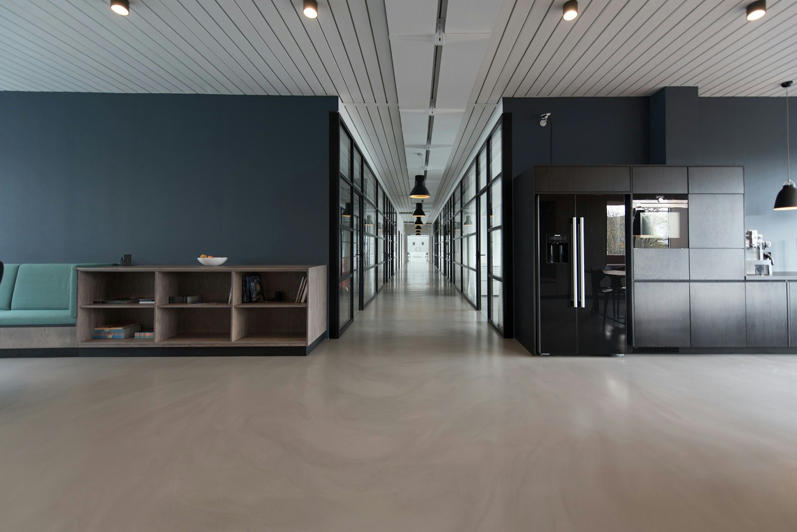 Open office with long work tables and daylight