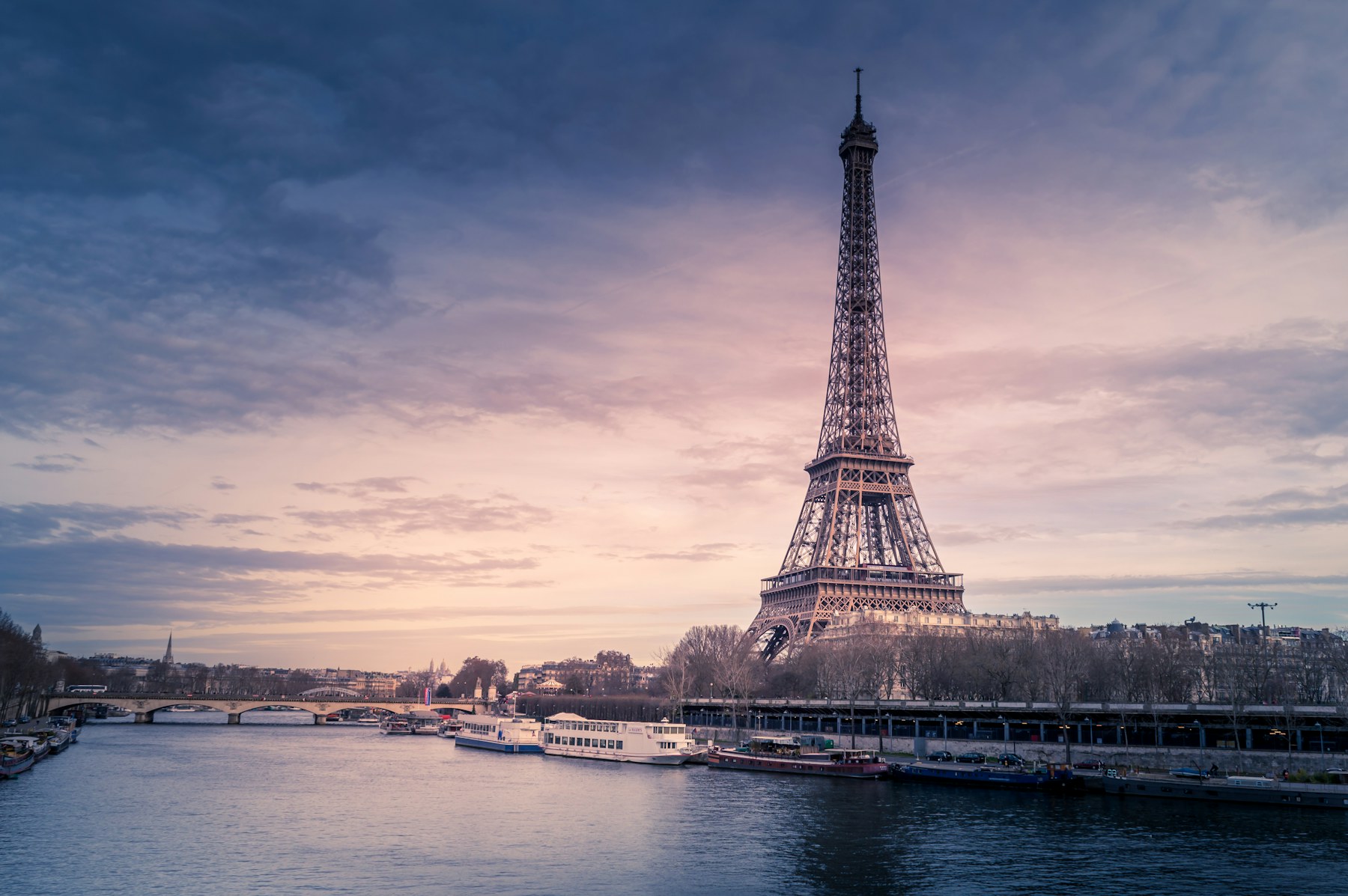 Paris at dusk — Haussmann rooftops along the Seine